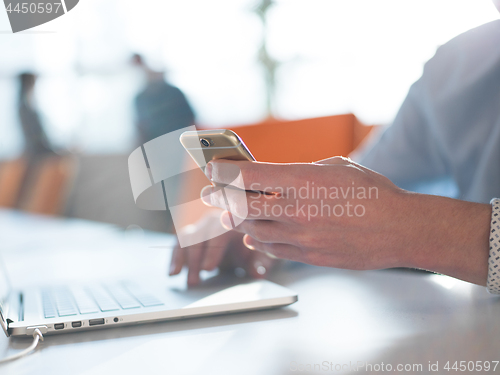 Image of Young man holding smartphone