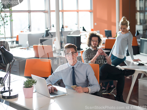 Image of businessman working using a laptop in startup office