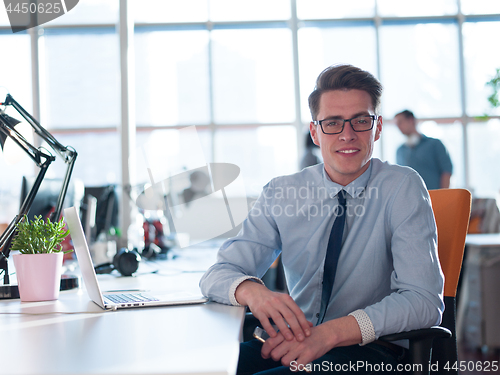 Image of businessman working using a laptop in startup office