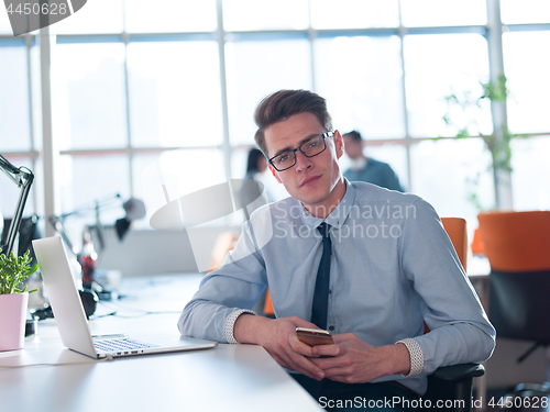 Image of businessman working using a laptop in startup office