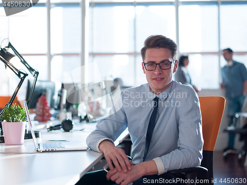 Image of businessman working using a laptop in startup office