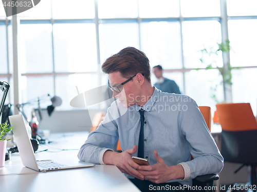 Image of businessman working using a laptop in startup office