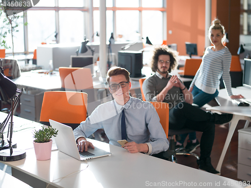 Image of businessman working using a laptop in startup office