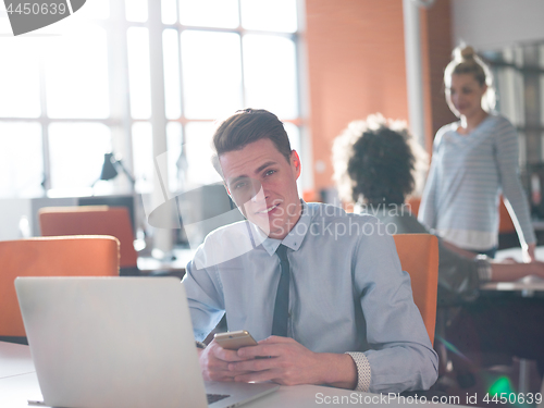 Image of businessman working using a laptop in startup office