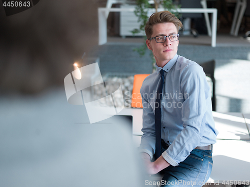 Image of young businessman in startup office