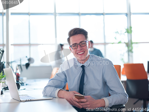 Image of businessman working using a laptop in startup office