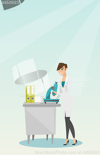 Image of Laboratory assistant with a microscope.