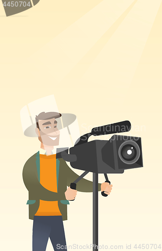 Image of Cameraman with a movie camera on tripod.