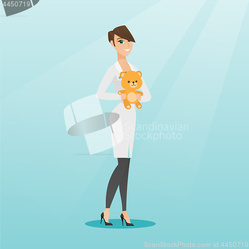 Image of Pediatrician doctor holding teddy bear.