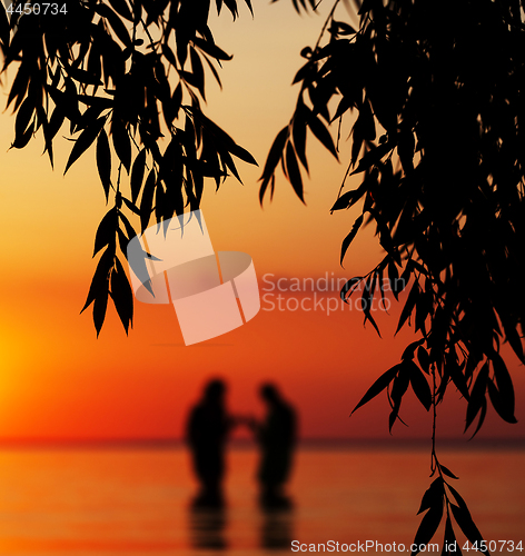 Image of Blurred silhouette of young couple in love