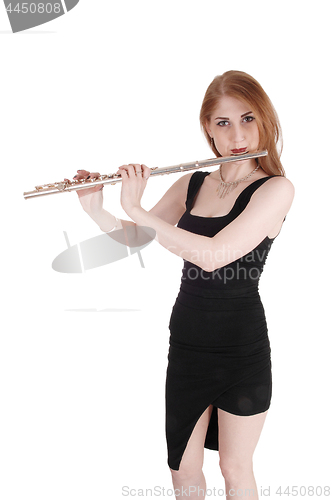 Image of Woman standing, playing the flute