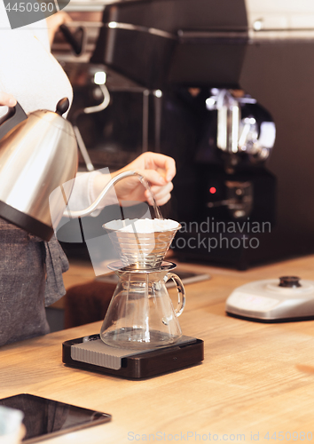 Image of Hand drip coffee, Barista pouring water on coffee ground with filter