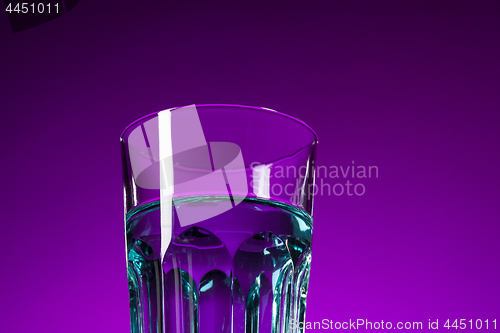 Image of The water in glass on lilac background