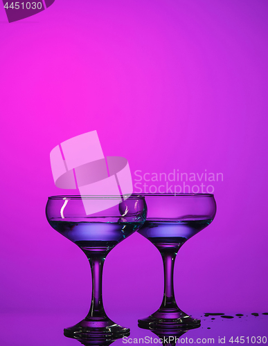 Image of Two wine glasses standing on the table at studio