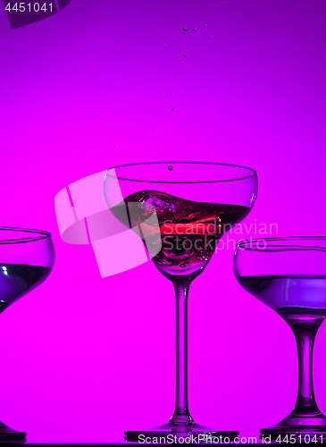 Image of Three wine glasses standing on the table at studio