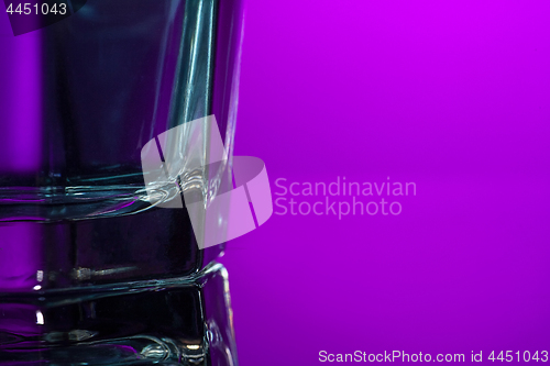 Image of The water in glass on lilac background