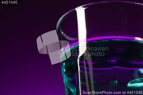 Image of The water in glass on lilac background