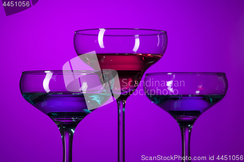 Image of Three wine glasses standing on the table at studio