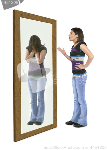 Image of Woman scolding herself in a mirror