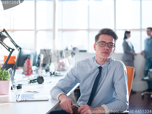 Image of businessman working using a laptop in startup office