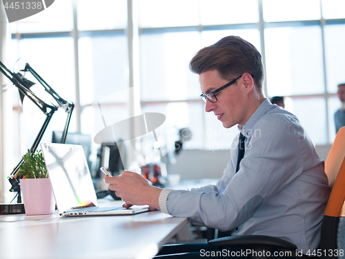 Image of businessman working using a laptop in startup office