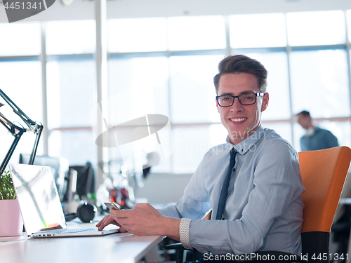 Image of businessman working using a laptop in startup office