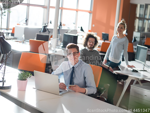 Image of businessman working using a laptop in startup office