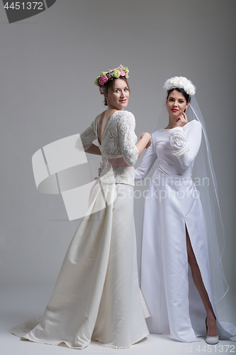 Image of Portrait of two beautiful young bride in wedding dresses