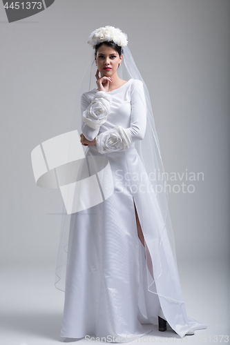 Image of young bride in a wedding dress with a veil