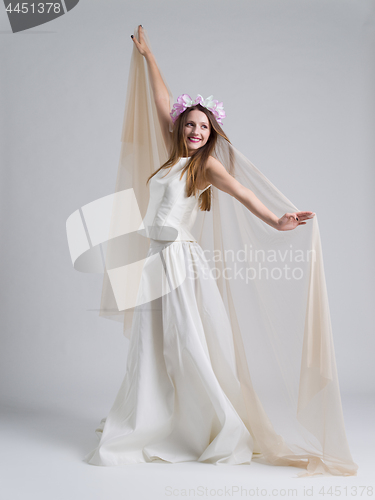 Image of young bride in a wedding dress with a veil