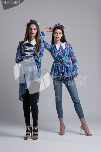 Image of two Fashion Model girls isolated over white background