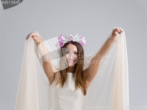 Image of young bride in a wedding dress with a veil