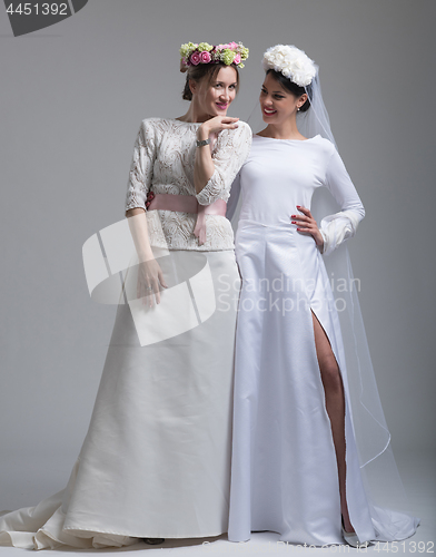 Image of Portrait of two beautiful young bride in wedding dresses