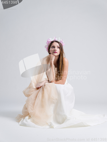 Image of young bride sitting in a wedding dress