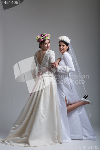 Image of Portrait of two beautiful young bride in wedding dresses