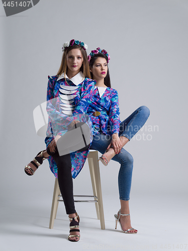 Image of two Fashion Model girls isolated over white background