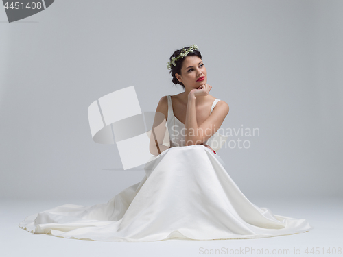 Image of young bride sitting in a wedding dress