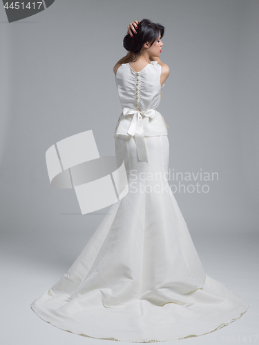 Image of Rear view of a beautiful young woman in a wedding dress