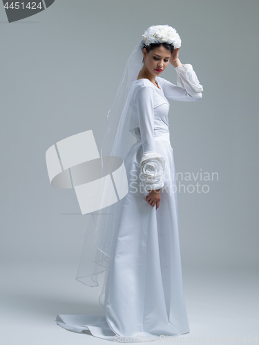 Image of young bride in a wedding dress with a veil