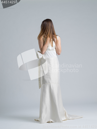 Image of Rear view of a beautiful young woman in a wedding dress