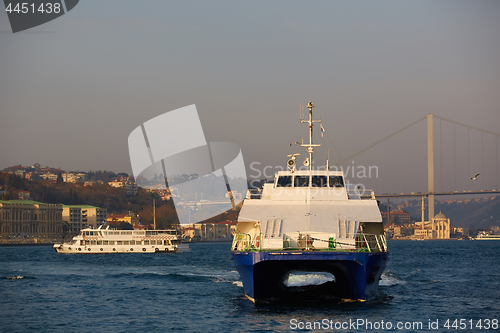 Image of Tourist boat sails on the Golden Horn in Istanbul at sunset, Turkey.
