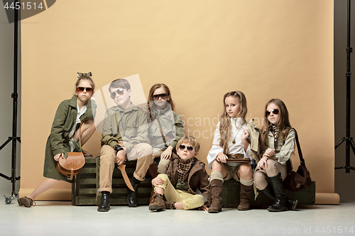 Image of The group of beautiful girls and boys on a pastel background