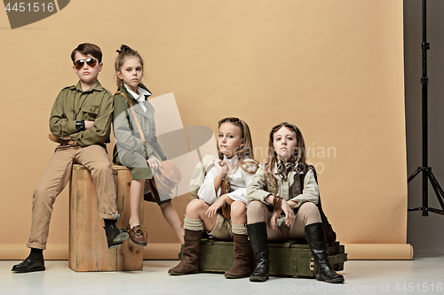 Image of The group of beautiful girls and boys on a pastel background