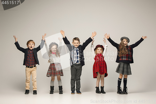 Image of The group of beautiful girls and boys on a pastel background