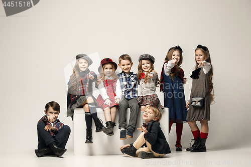 Image of The group of beautiful girls and boys on a pastel background