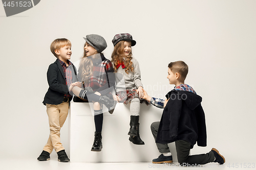 Image of The group of beautiful girls and boys on a pastel background