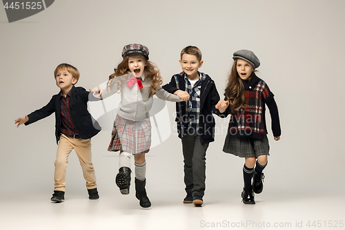 Image of The group of beautiful girls and boys on a pastel background