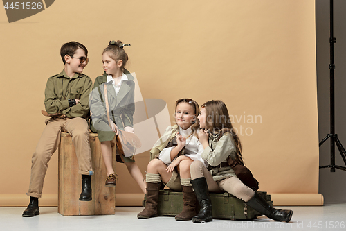 Image of The group of beautiful girls and boys on a pastel background