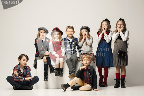 Image of The group of beautiful girls and boys on a pastel background