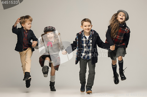 Image of The group of beautiful girls and boys on a pastel background